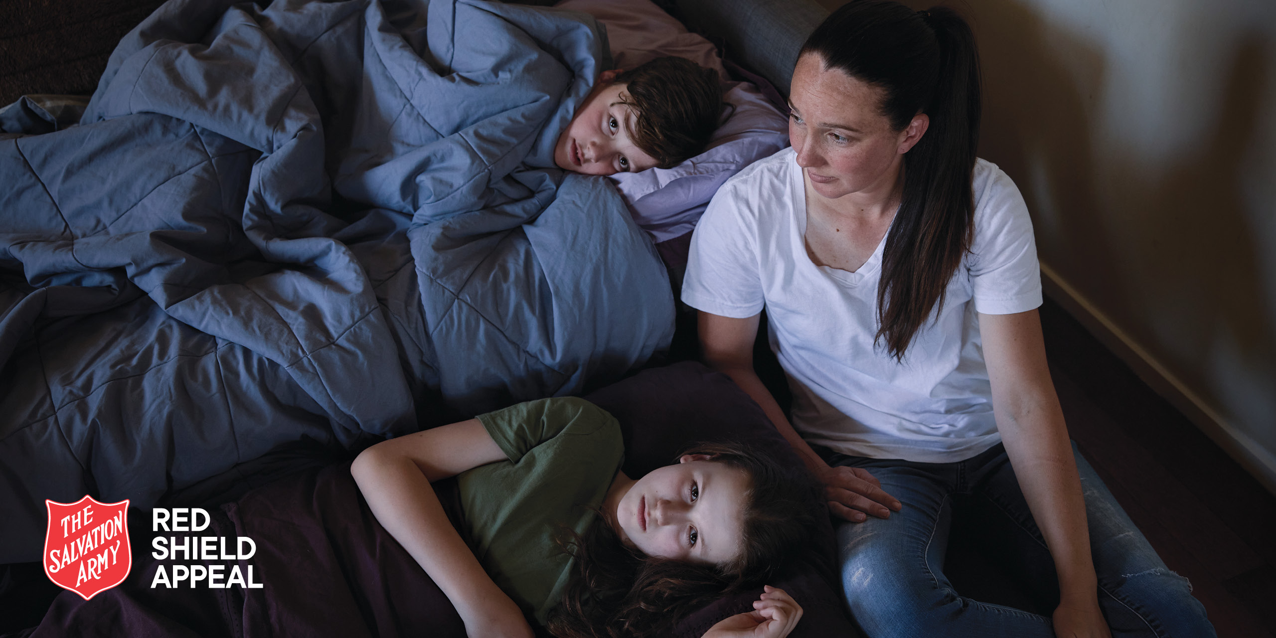 Naomi and her children sleeping together in a rental home, struggling due to housing crisis.